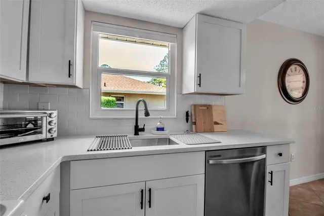 a kitchen with a sink cabinets and window