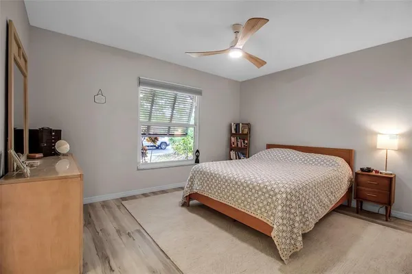 a bedroom with a bed and a window