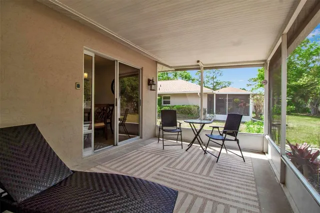 a view of a patio with a dining table and chairs