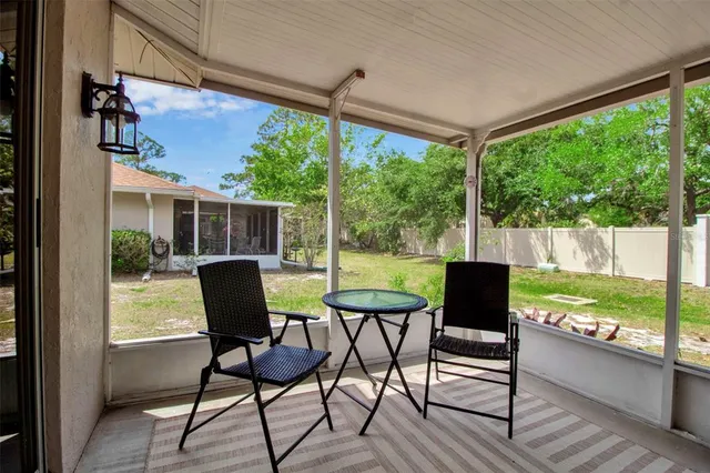 a view of a patio with table and chairs and wooden floor