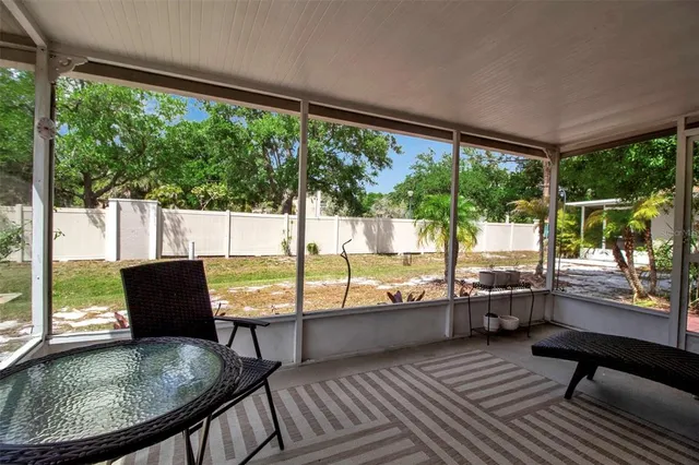 a view of a porch with furniture and a yard