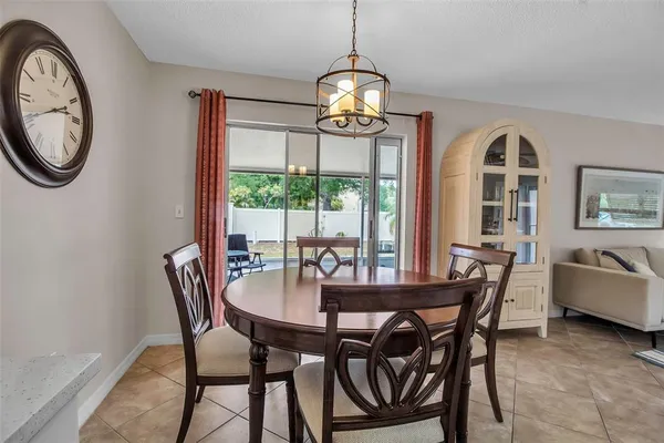 a dining room with furniture a chandelier and a rug
