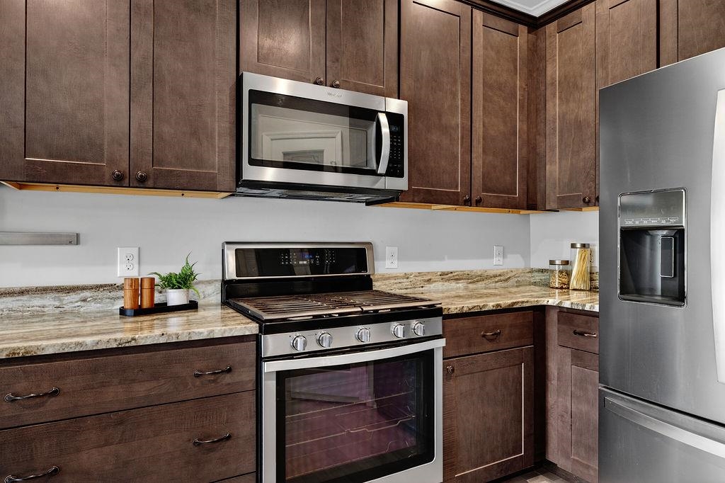 190 Montgomery Road Staunton, VA 24401 - Photo 12 of 46 a kitchen with granite countertop a stove microwave and refrigerator