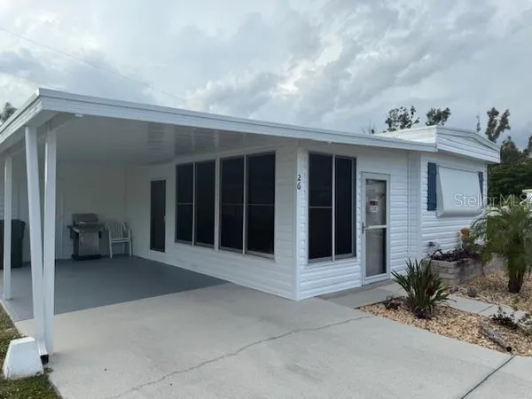 a view of a house with a yard and seating space