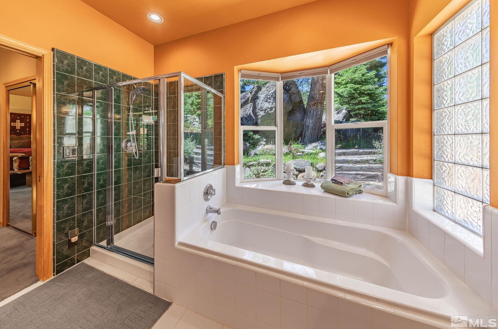 228 Sunflower Circle Stateline, NV 89449 - Photo 16 of 40 a bathroom with a bathtub and shower