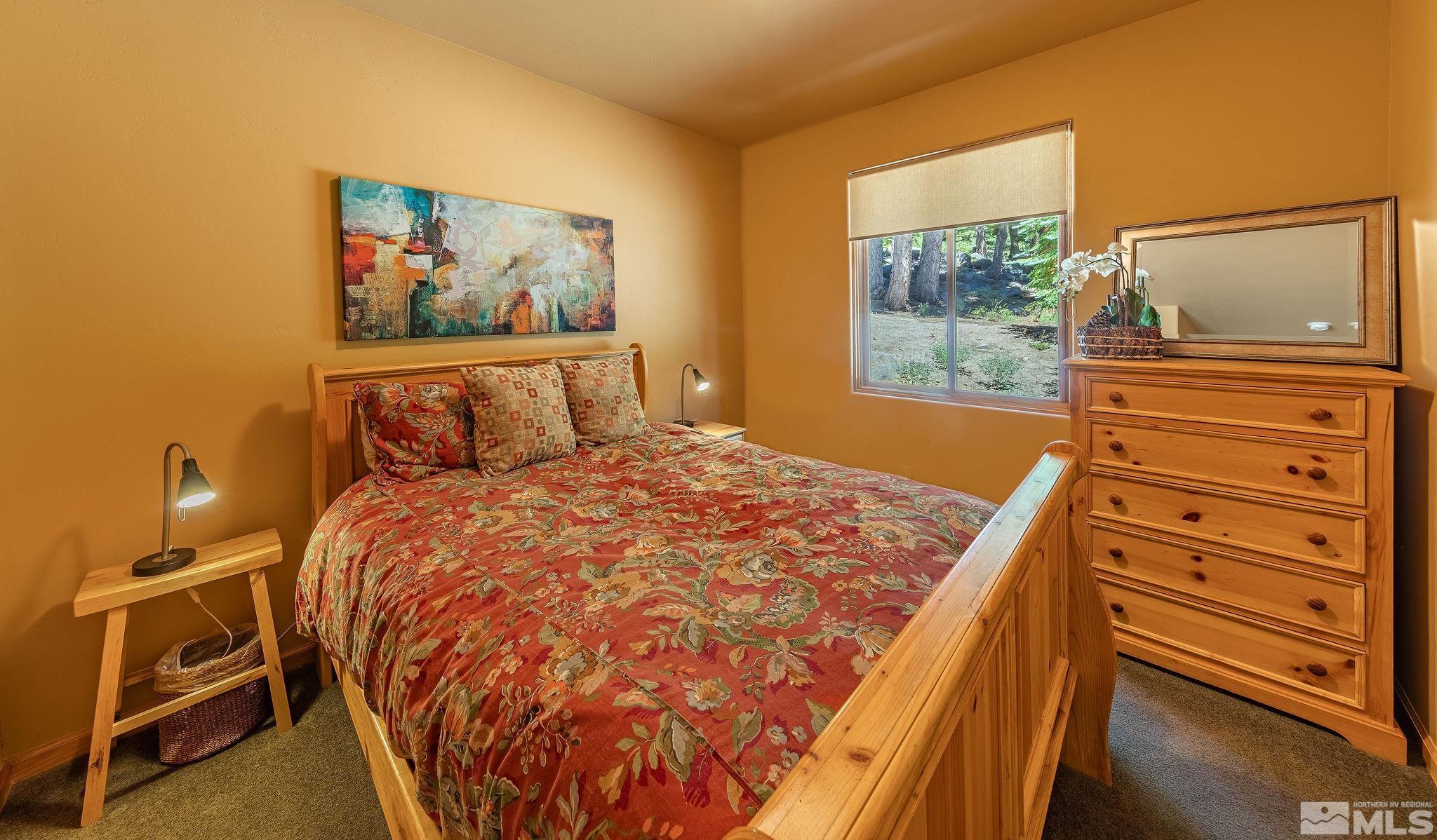 228 Sunflower Circle Stateline, NV 89449 - Photo 17 of 40 a bed sitting in a bedroom next to a window