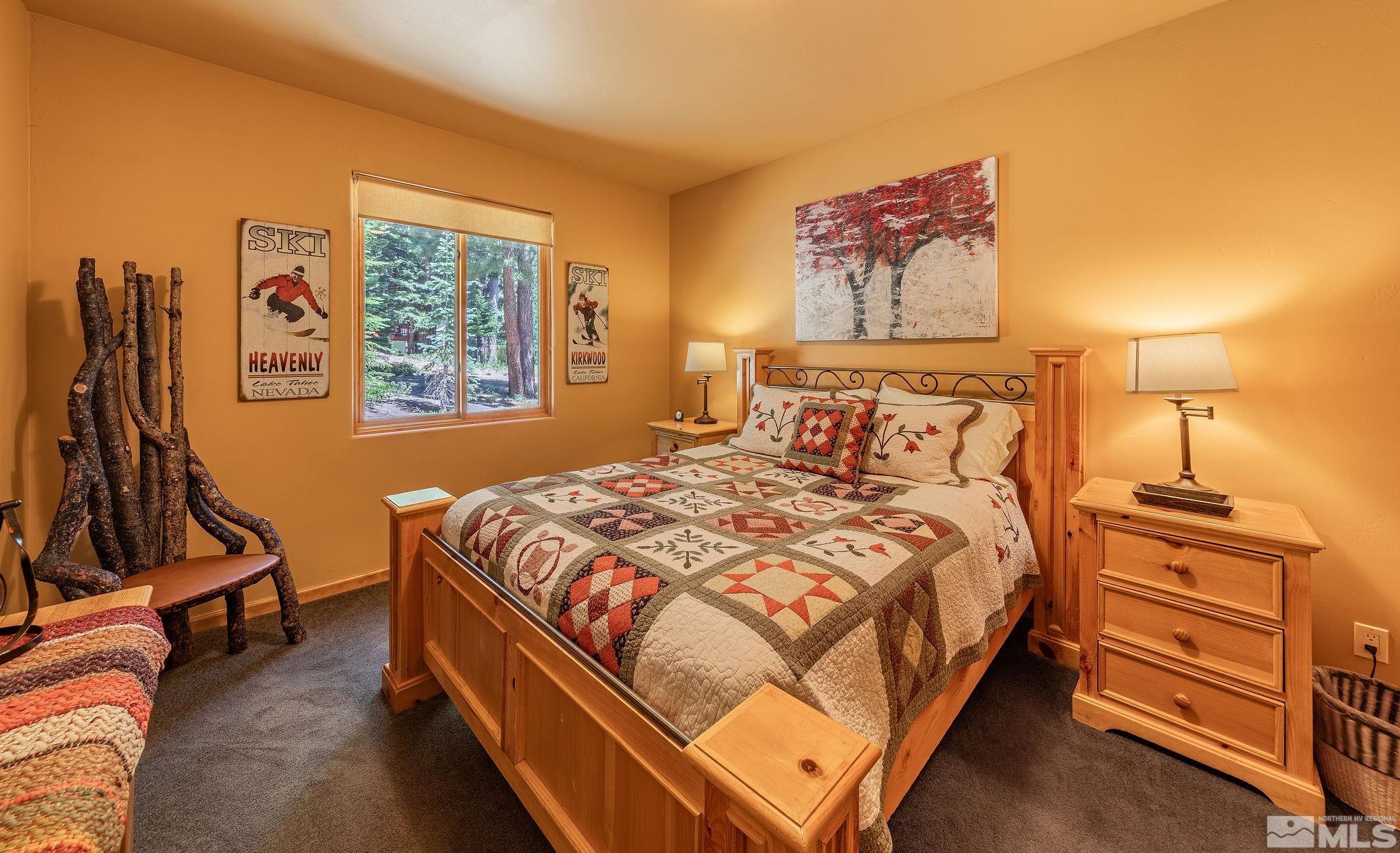 228 Sunflower Circle Stateline, NV 89449 - Photo 18 of 40 a bedroom with a bed and wooden floor