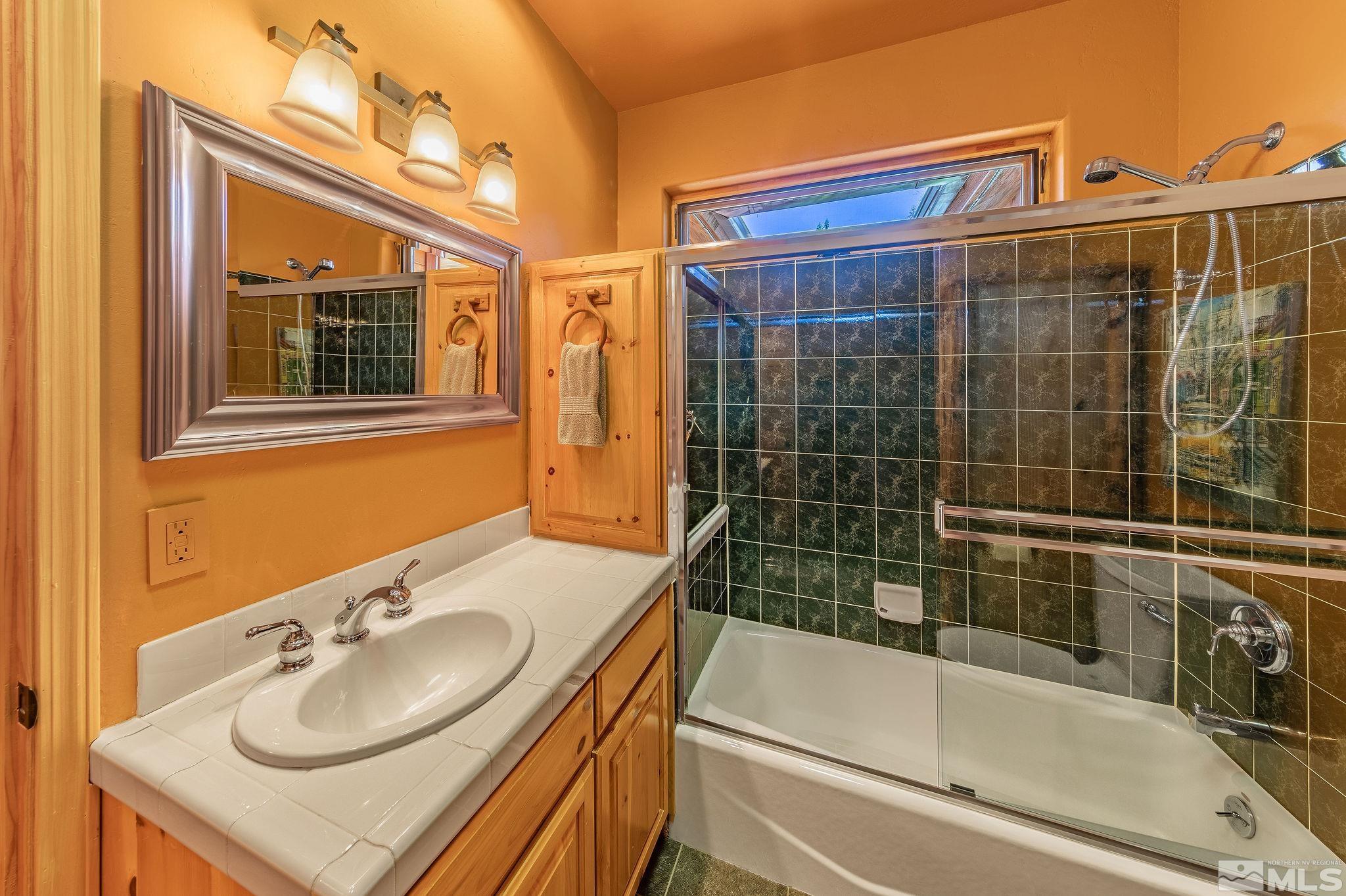 228 Sunflower Circle Stateline, NV 89449 - Photo 19 of 40 a bathroom with a sink vanity tub and shower
