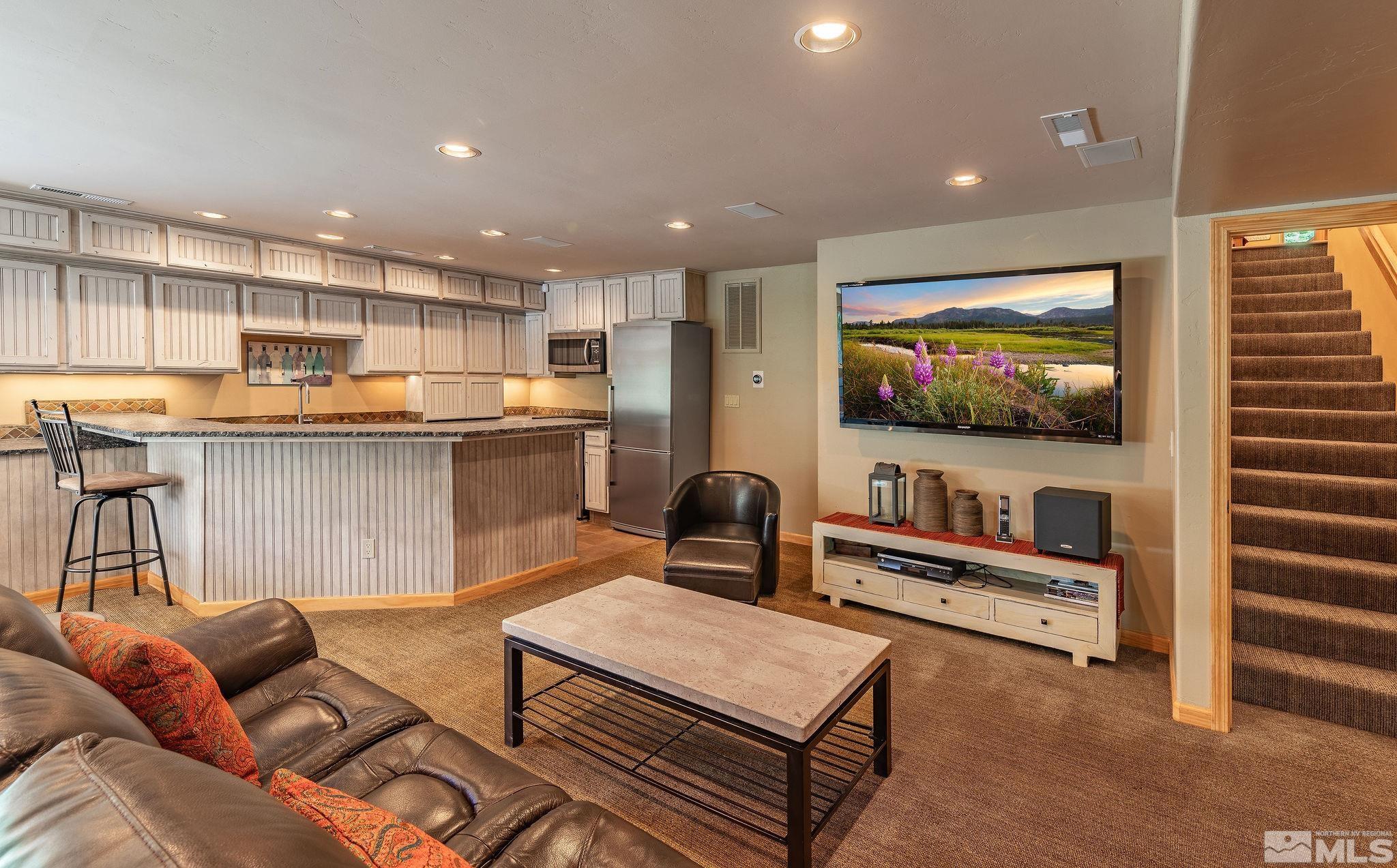 228 Sunflower Circle Stateline, NV 89449 - Photo 20 of 40 a living room with furniture and a flat screen tv