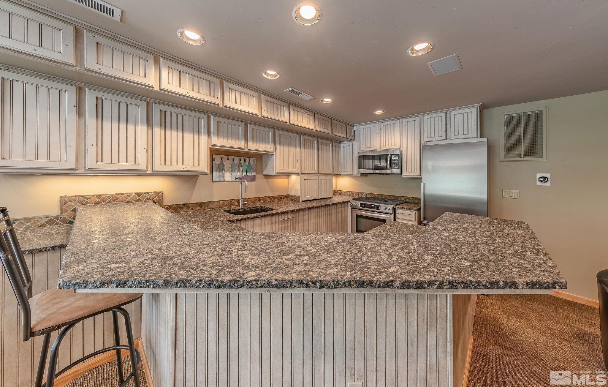 228 Sunflower Circle Stateline, NV 89449 - Photo 21 of 40 a kitchen with large windows