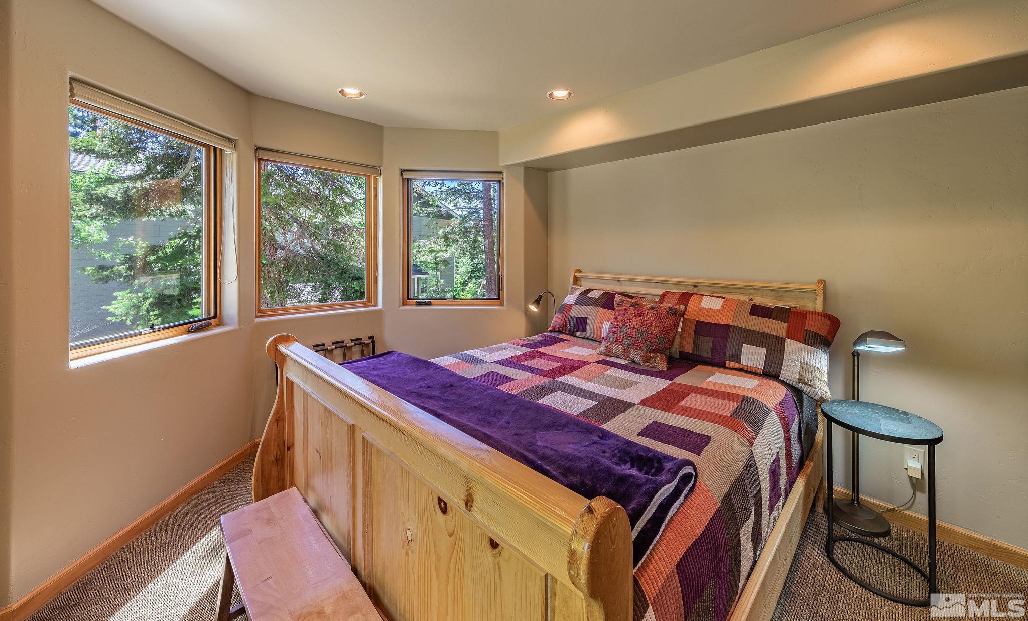 228 Sunflower Circle Stateline, NV 89449 - Photo 23 of 40 a bed sitting in a bedroom next to a window