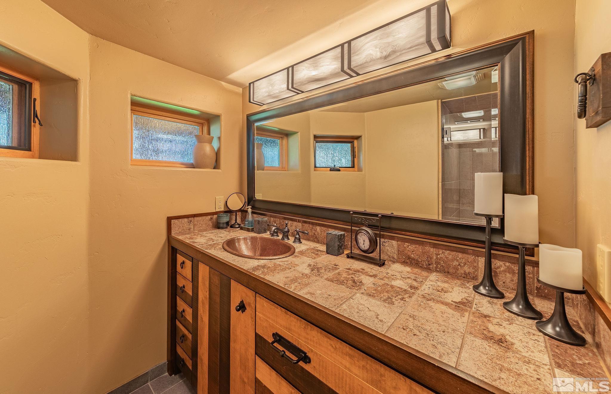 228 Sunflower Circle Stateline, NV 89449 - Photo 25 of 40 a bathroom with a sink and a mirror