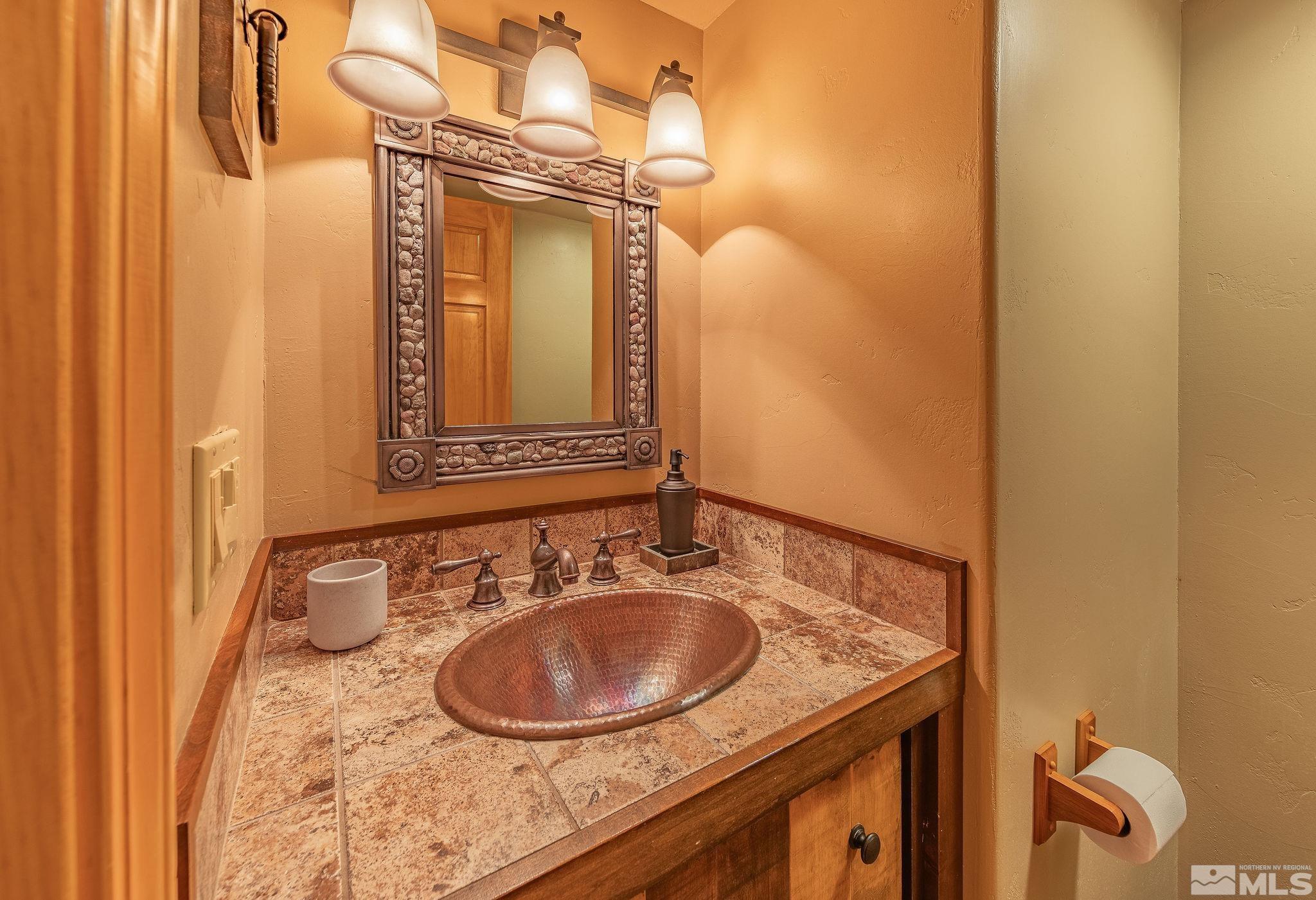 228 Sunflower Circle Stateline, NV 89449 - Photo 26 of 40 a bathroom with a sink and a mirror