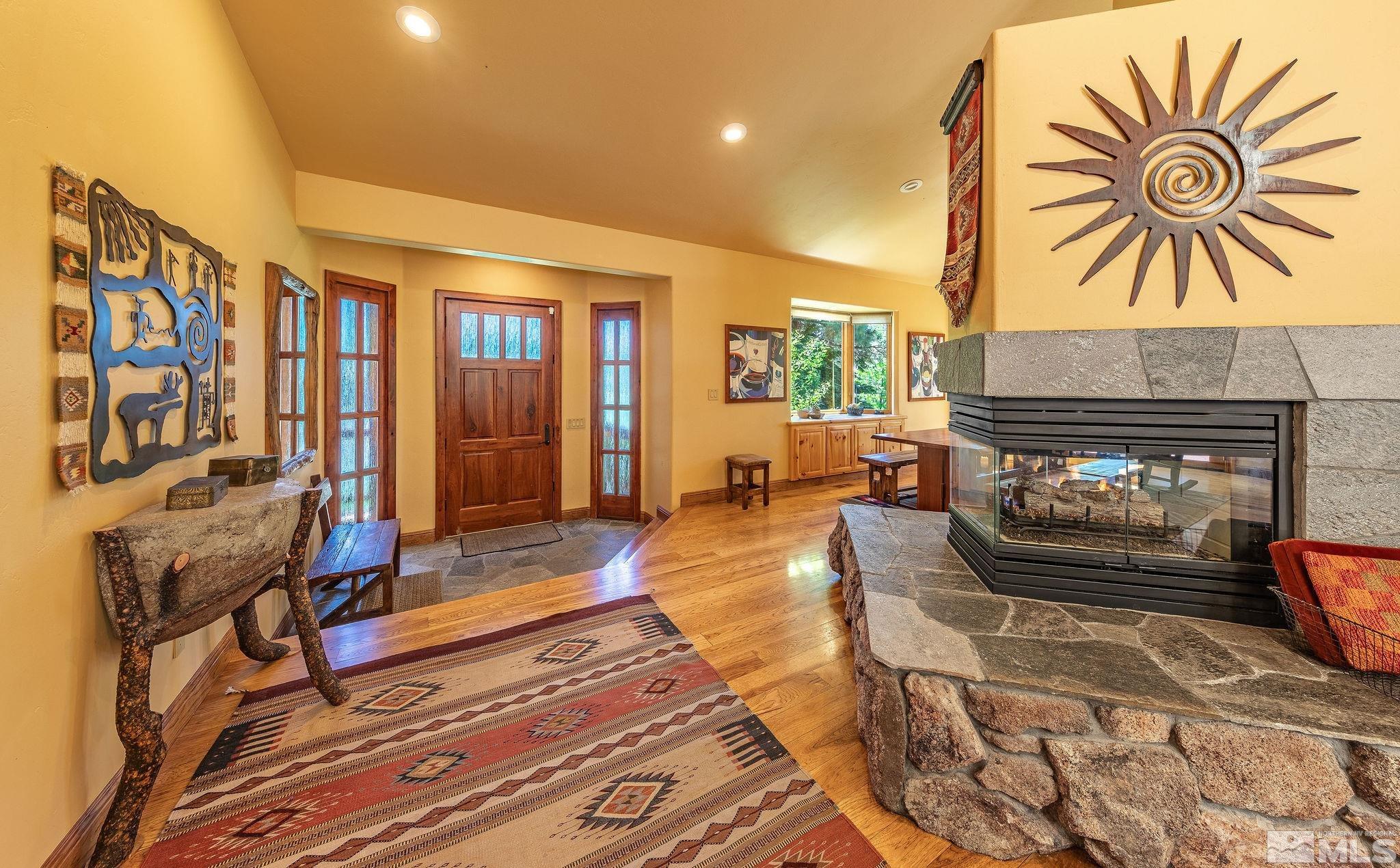228 Sunflower Circle Stateline, NV 89449 - Photo 5 of 40 a living room with furniture a fireplace and a flat screen tv