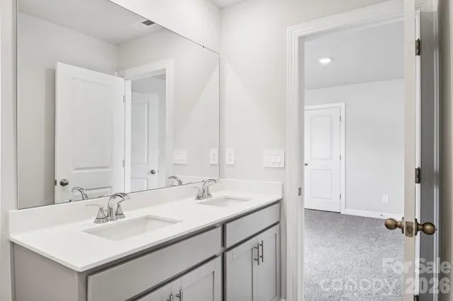 a bathroom with a shower and a glass door