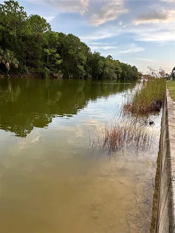 a view of a lake with houses in the back