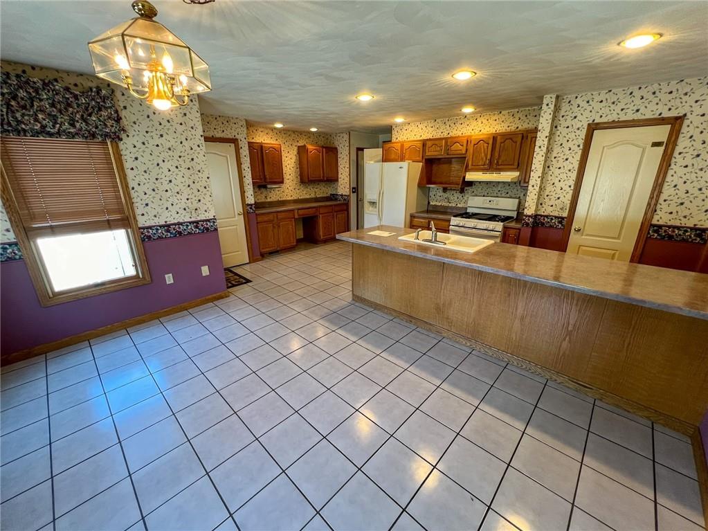 167 Moore Road Butler, PA 16001 - Photo 12 of 50 a large kitchen with stainless steel appliances granite countertop a sink and cabinets