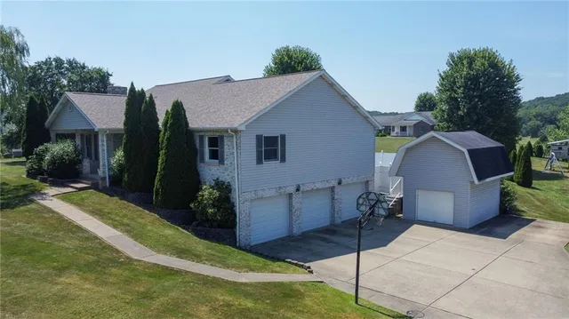 a view of a house with backyard and sitting area
