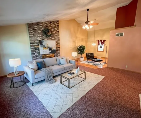 a living room with furniture and a chandelier