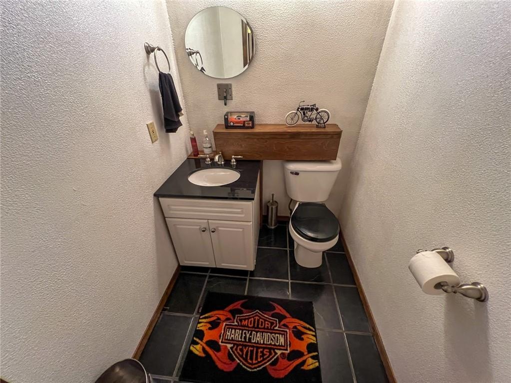 167 Moore Road Butler, PA 16001 - Photo 44 of 50 a bathroom with a toilet a sink and a mirror