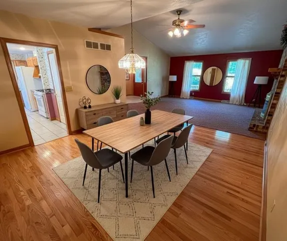 a view of a dining room with furniture and a chandelier