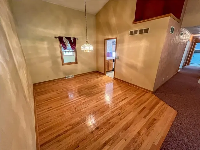 a view of a room with wooden floor