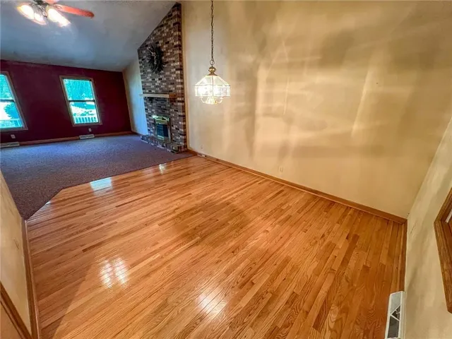 a view of empty room with window and fireplace
