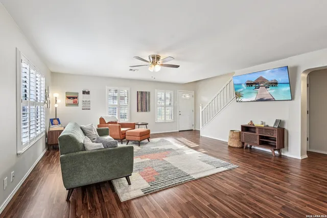 a living room with furniture and a wooden floor