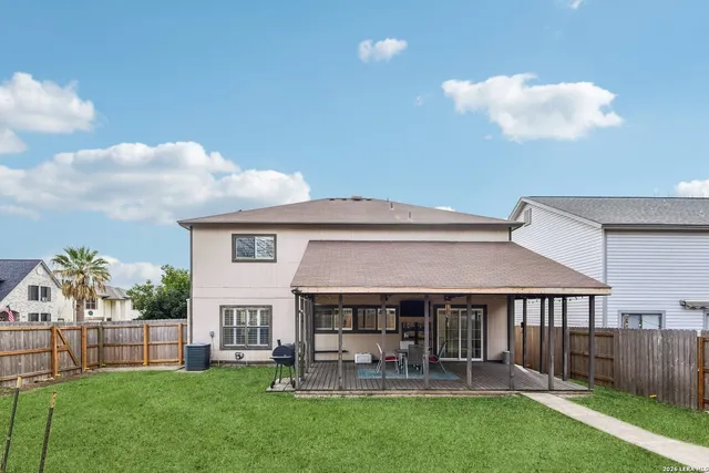 a view of house with a big yard and potted plants