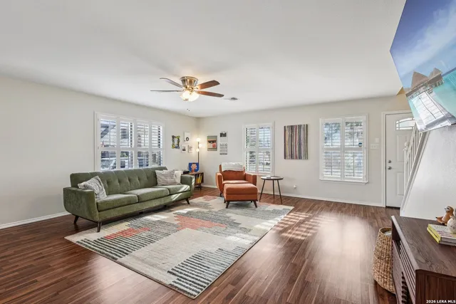 a living room with furniture and a wooden floor