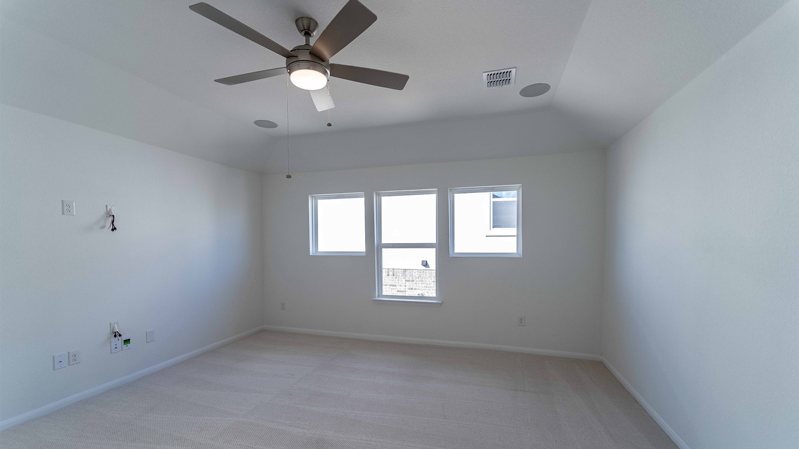 294 Rubber Tree Way Buda, TX 78610 - Photo 13 of 19 Spare room featuring light carpet, a ceiling fan, and vaulted ceiling