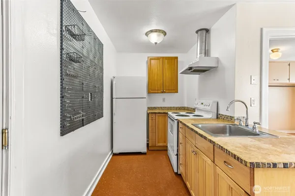 a kitchen with a sink a stove and a refrigerator
