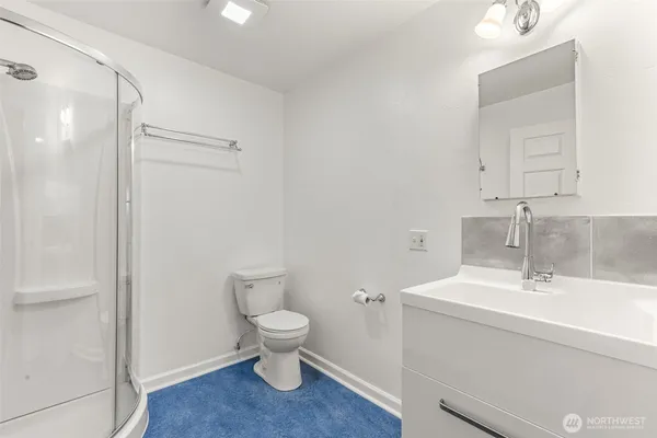 a bathroom with a sink a toilet and a mirror
