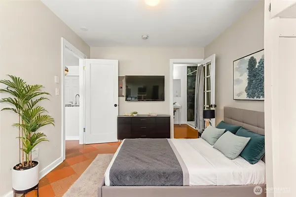 a bedroom with a bed and a flat screen tv