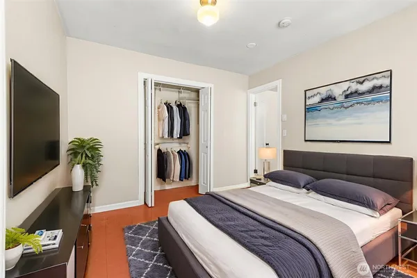 a bedroom with a bed and a flat screen tv