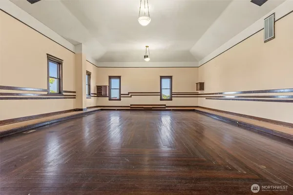 a view of a kitchen with wooden floor and a window