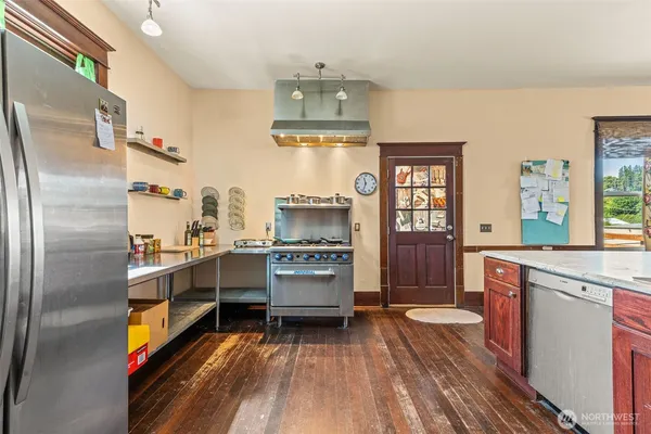 a kitchen with stainless steel appliances a stove and a refrigerator