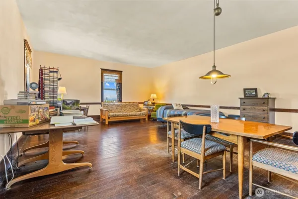a living room with furniture a wooden floor and a chandelier