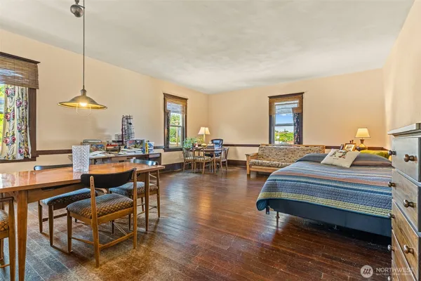 a living room with furniture window and wooden floor