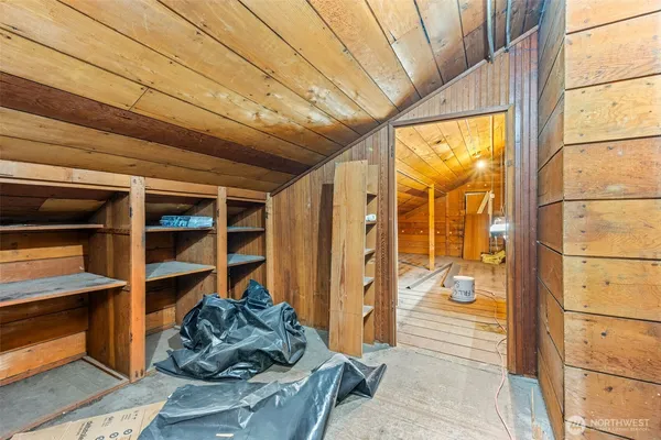 a view of a bedroom with wooden floor and furniture
