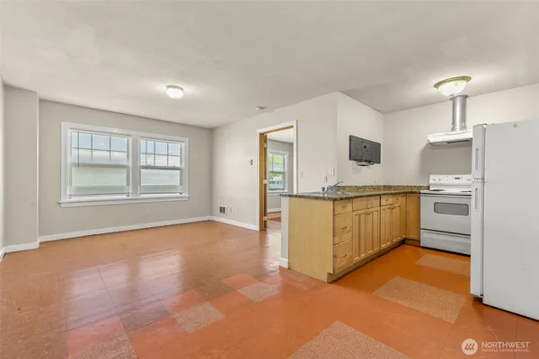 a view of a kitchen with microwave and cabinets