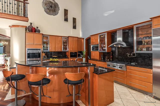 a living room with furniture a flat screen tv and a floor to ceiling window