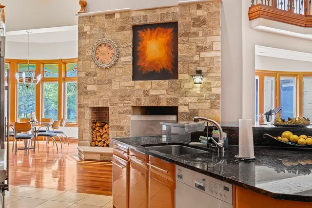 a kitchen with stainless steel appliances kitchen island granite countertop a refrigerator and a stove top oven