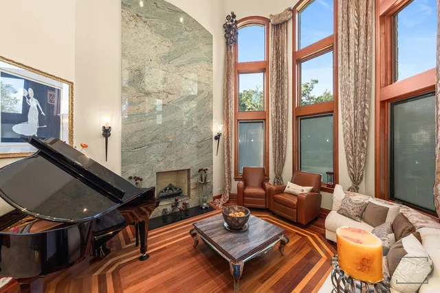 a spacious bedroom with a bed and a chandelier