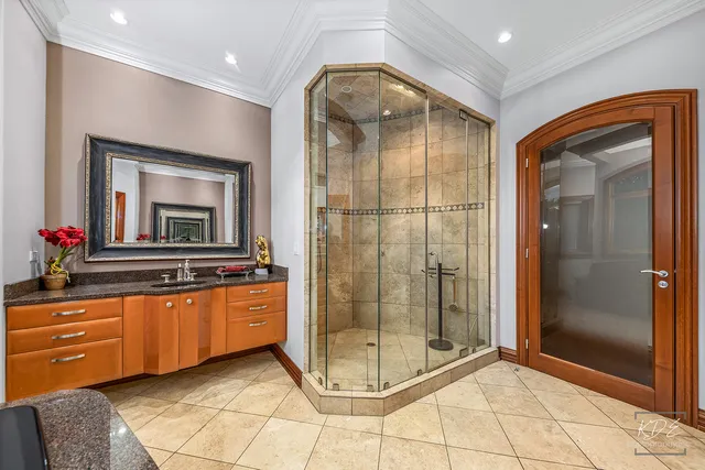 a bathroom with a granite countertop sink a mirror and shower