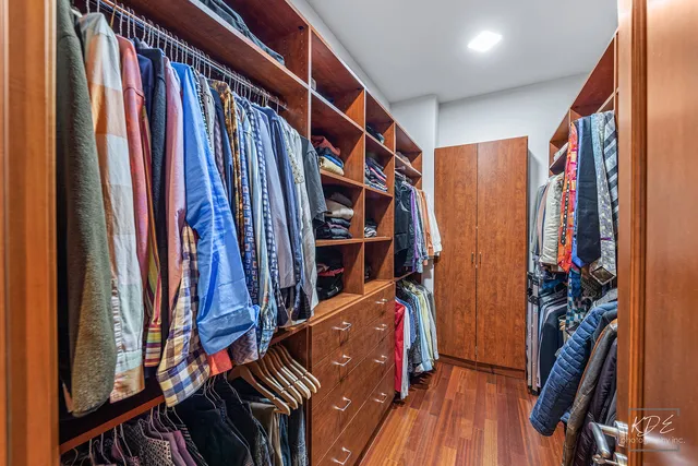 a kitchen with stainless steel appliances granite countertop a refrigerator a stove and a sink