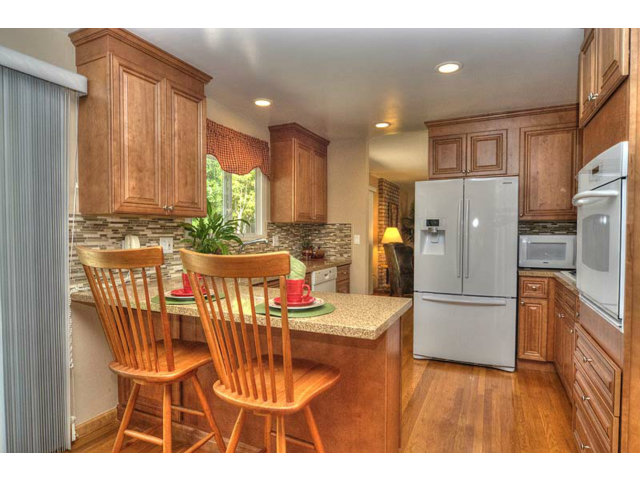 807 Haverhill Drive Sunnyvale, CA 94087 - Photo 9 of 20 a kitchen with stainless steel appliances kitchen island granite countertop a refrigerator a stove a sink dishwasher with a dining table and chairs