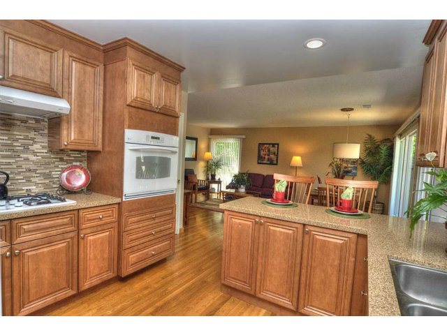 807 Haverhill Drive Sunnyvale, CA 94087 - Photo 10 of 20 a living room with stainless steel appliances kitchen island granite countertop a refrigerator a stove a sink dishwasher and wooden cabinets with wooden floor