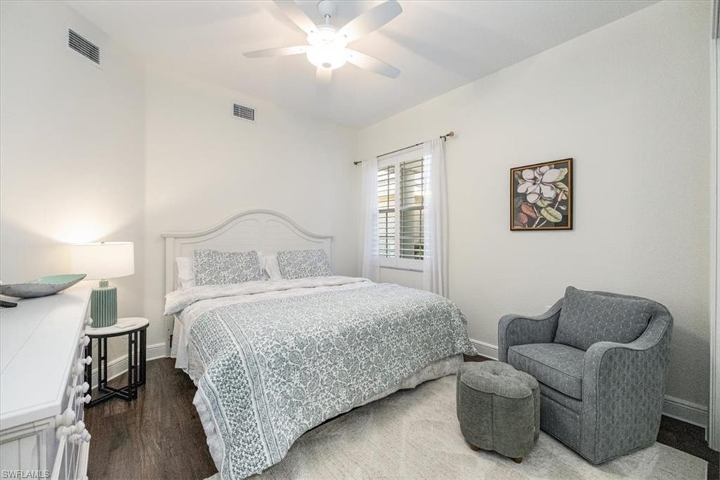 730 Regency Reserve Circle, Unit 2802 Naples, FL 34119 - Photo 11 of 22 a bedroom with bed and a window