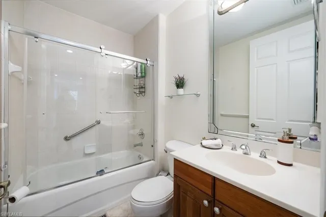 a bathroom with a sink mirror toilet and bathtub